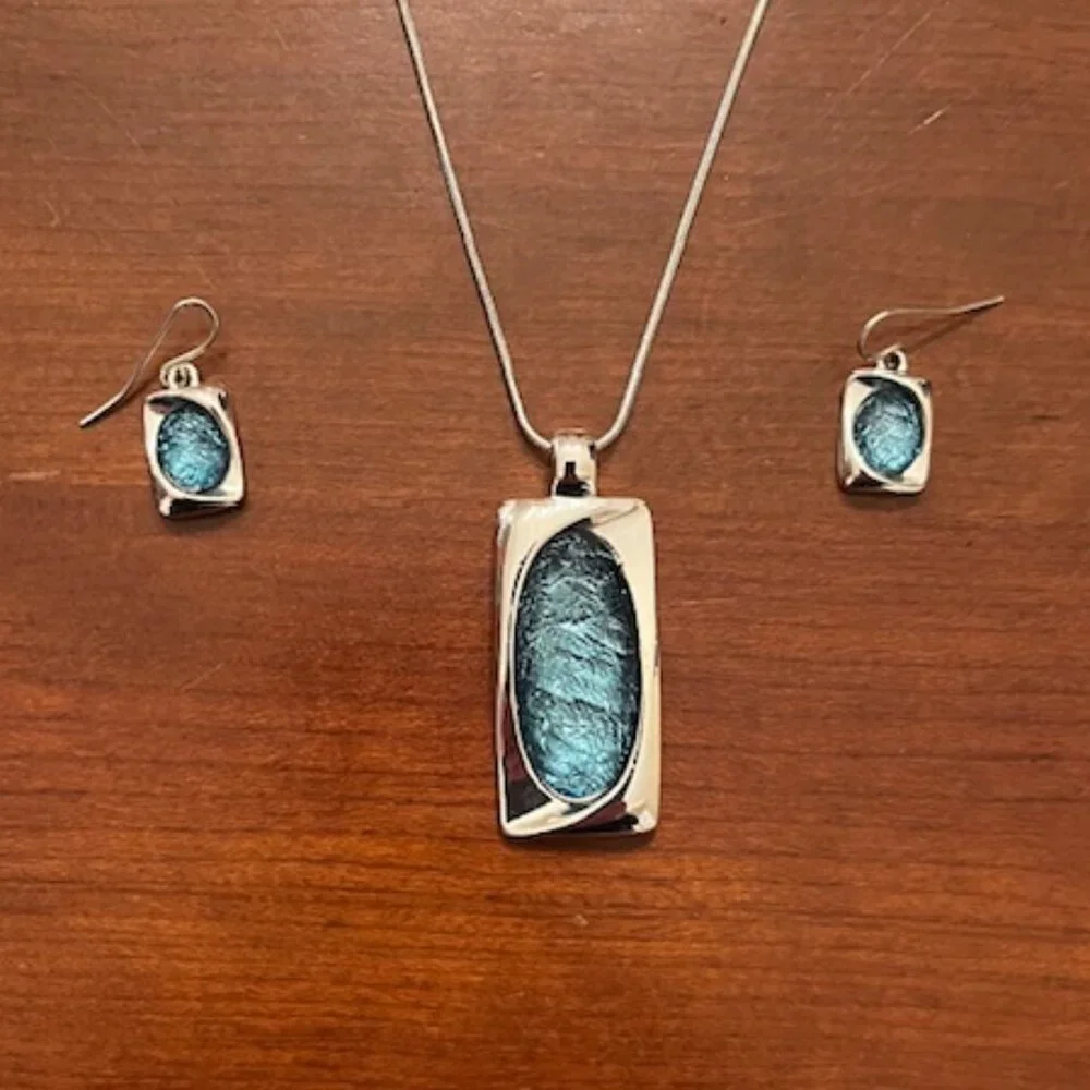 Aqua blue glass pendant and silver tone chain with matching earrings